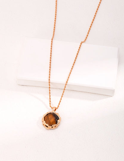 Hand-carved volcanic lava texture tiger eye stone pendant. When the petrified wood tiger eye stone meets the hand-inlaid silver tray, the texture of the mountain rock melts and flows slowly around the dazzling gem.