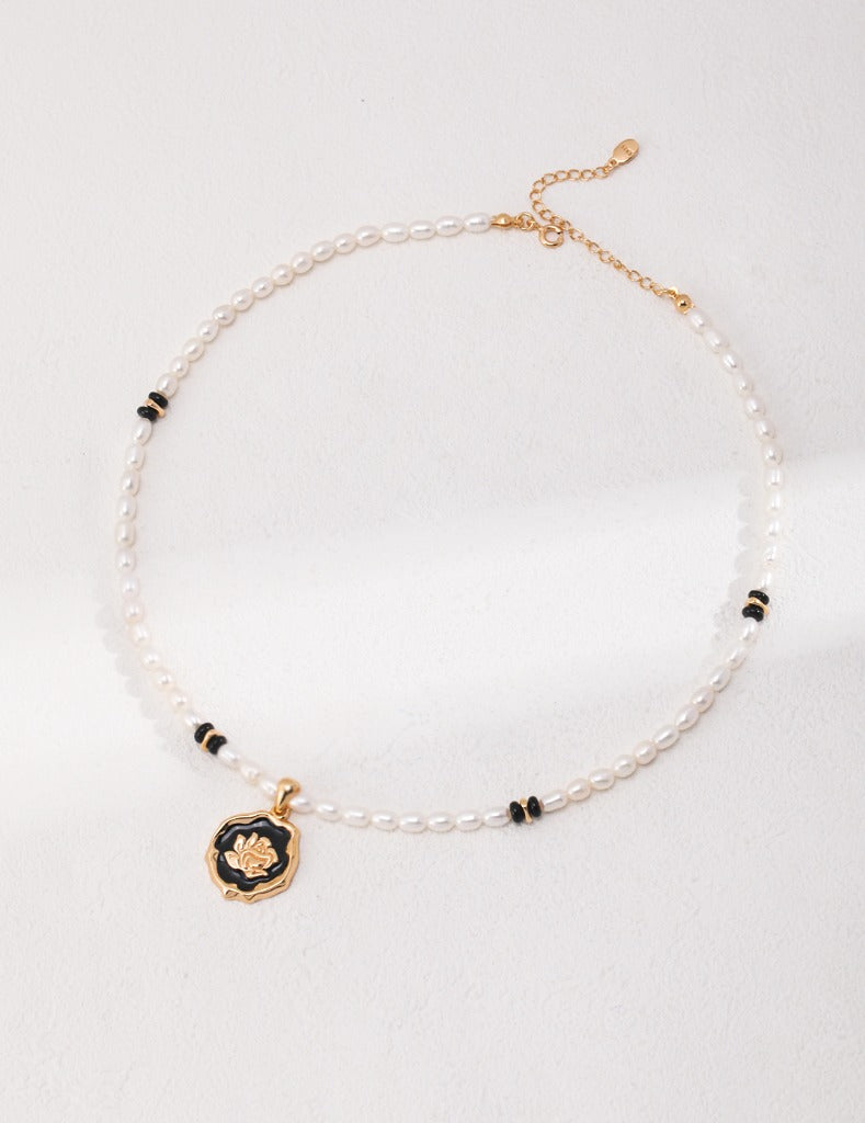 The fashion and exquisiteness of the Chanel style, the thorns guard the moving splendor of the rose. The pearl necklace embellishment and the agate and sterling silver spacers break the tradition.